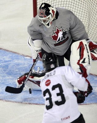 CALGARY, CANADA - AUGUST 24: Martin Brodeur makes a stop on Andy McDonald during the second practice of the Team Canada Olympic Orientation Camp on August 24, 2009 at the Pengrowth Saddledome in Calgary, Alberta, Canada. (Photo by Mike Ridewood/Getty Imag