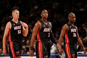 NEW YORK - JANUARY 26:  Dwyane Wade #3 (C) of the Miami Heat walks to the bench with teammates Michael Doleac #51 (L) and Gary Payton #20 against the New York Knicks January 26, 2007 at Madison Square Garden in New York City. NOTE TO USER: User expressly 