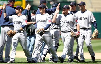 OAKLAND, CA - APRIL 15:  The Boston Red Sox celebrate after defeating the Oakland Athletics during a Major League Baseball game at the Oakland Coliseum April 15, 2009 in Oakland, California. All Major League Baseball players are wearing #42 in honor of Ja
