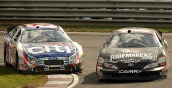 MONTREAL, CANADA - AUGUST 30: Carl Edwards, driver of the #60 CitiFinancial Ford and Andrew Ranger, driver of the #11 Ridemakerz Toyota battle for position during the Napa Auto Parts 200 on August 30, 2009 at the Circuit Gilles Villeneuve in Montreal, Q