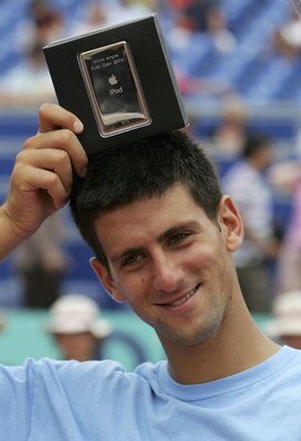 AMERSFOORT, NETHERLANDS - JULY 23:  Novak Djokovic of Serbia & Montenegro celebrates defeating Nicolas Massu of Chile in straight sets with his prize - an ipod after the final during the Dutch Open Tennis on July 23, 2006 in Amersfoort, Netherlands.  (Pho