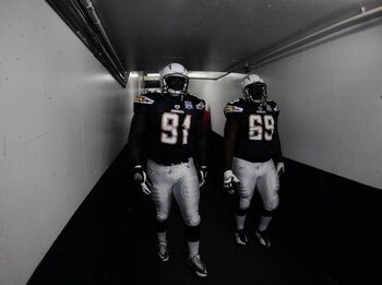 SAN DIEGO - AUGUST 15:  Ogemdi Nwagbuo #91 and Tyronne Green #69 of the San Deigo Chargers walk onto the feild to play the Seattle Seahawks on August 15, 2009 in San Diego, California.  (Photo by Jacob de Golish/Getty Images)