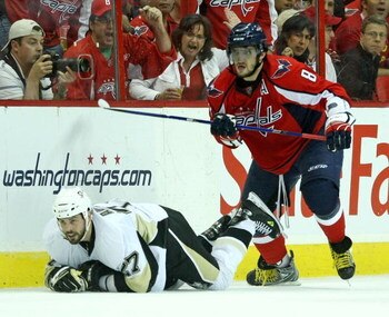 WASHINGTON - MAY 13: Alex Ovechkin #8 of the Washington Capitals hits Craig Adams #27 of the Pittsburgh Penguins during Game Seven of the Eastern Conference Semifinal  Round of the 2009 Stanley Cup Playoffs at Verizon Center on May 13, 2009 in Washington,