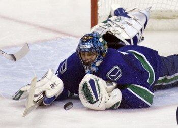 VANCOUVER, CANADA - APRIL 30: Goalie Roberto Luongo #1 of the Vancouver Canucks dives to cover the puck after making a save against the Chicago Blackhawks during Game One of the Western Conference Semifinal Round of the 2009 Stanley Cup Playoffs on April 