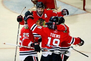 CHICAGO - MAY 24:  (L-R) Cam Barker #25, Patrick Sharp #10, Jonathan Toews #19 and Patrick Kane #88 of the Chicago Blackhawks celebrate after Toews scored a goal in the second period against the Detroit Red Wings during Game Four of the Western Conference