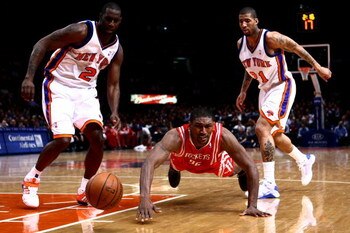 NEW YORK - JANUARY 26: Ron Artest #96 of the Houston Rockets dives for the ball in front of Tim Thomas #2 and Wilson Chandler #21 of the New York Knicks at Madison Square Garden January 26, 2009 in New York City. NOTE TO USER: User expressly acknowledges 