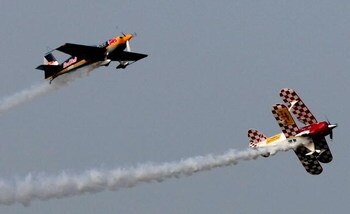 YOKOHAMA, JAPAN - JULY 20:  Yoshihide Muroya of Japan and Sunny (R) in flight during the Red Bull Flight Performance 2008 at Yokohama Minato Mirai Area on July 20, 2008 in Yokohama, Kanagawa, Japan.  (Photo by Koichi Kamoshida/Getty Images)