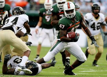 MIAMI - OCTOBER 25:  Wide receiver Laron Byrd #47 of the Miami Hurricanes looks to avoid a tackle by defensive end Michael Lockett #99 and cornerback Michael Williams #24 of the Wake Forest Demon Decons at Dolphin Stadium on October 25, 2008 in Miami, Flo