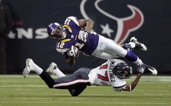 HOUSTON - AUGUST 31:  Percy Harvin #12 of the Minnesota Vikings is tackled by Glenn Martinez #17 of the Houston Texans on the opening kick-off at Reliant Stadium on August 31, 2009 in Houston, Texas.  (Photo by Bob Levey/Getty Images)