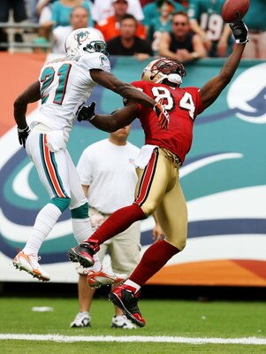 MIAMI - DECEMBER 14:  Cornerback Andre Goodman #21 of the Miami Dolphins tips the ball away from wide receiver Josh Morgan #84 of the San Francisco 49ers at Dolphin Stadium on December 14, 2008 in Miami, Florida.  (Photo by Doug Benc/Getty Images)