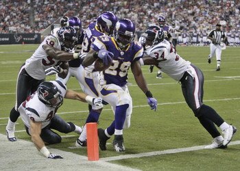 HOUSTON - AUGUST 31:  Running back Chester Taylor #29 of the Minnesota Vikings crosses the goal line for a score at the end of the second quarter before linebacker DeMeco Ryans #59 and safety Dominque Barber #34 can make the tackle at Reliant Stadium on A