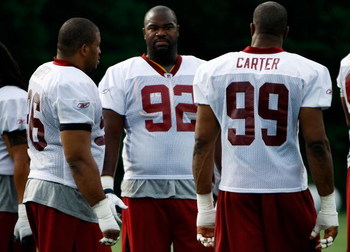 ASHBURN, VA - JULY 30: Washington Redskins defensive tackle Albert Haynesworth (#92) talks with defensive end Andre Carter (#99) and defensive tackle Cornelius Griffin (#96) during opening day of training camp July 30, 2009 in Ashburn, Virginia. (Photo