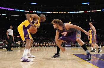 LOS ANGELES, CA - FEBRUARY 26:  Didier Ilunga-Mbenga #28 of the Los Angeles Lakers handles the ball under pressure from Robin Lopez #15 of the Phoenix Suns during the NBA game at Staples Center on February 26, 2009 in Los Angeles, California.   The Lakers