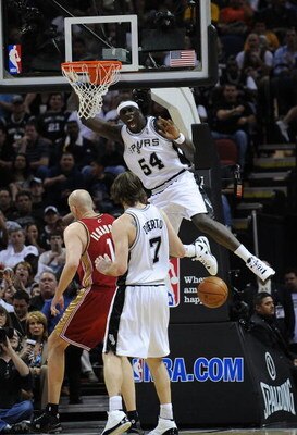 SAN ANTONIO - FEBRUARY 27:  Forward Pops Mensah-Bonsu #54 of the San Antonio Spurs reacts after getting a dunk against Zydrunas Ilgauskas #11 of the Cleveland Cavaliers on February 27, 2009 at AT&T Center in San Antonio, Texas.  NOTE TO USER: User express