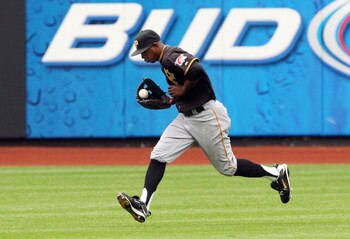 NEW YORK - MAY 09:  Nyjer Morgan #3 of the Pittsburgh Pirates fields the ball against the New York Mets on May 9, 2009 at Citi Field in the Flushing neighborhood of the Queens borough of New York City. The Mets defeated the Pirates 10-1.  (Photo by Jim Mc