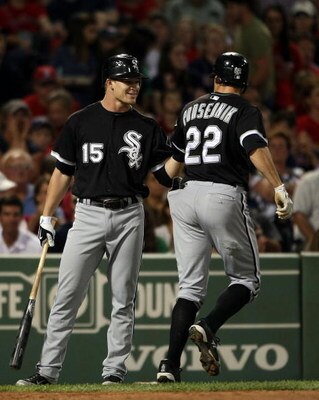 BOSTON - AUGUST 26:  Scott Podsednik #22 of the Chicago White Sox is congratulated by teammate Gordon Beckham #15 fter Podsednik hit a solo home run to tie the game in the 8th inning against the Boston Red Sox on August 26, 2009 at Fenway Park in Boston, 
