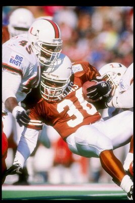 1 Jan 1991:  Running back Adrian Walker of the Texas Longhorns is tackled during the Cotton Bowl against the Miami Hurricanes at the Cotton Bowl in Dallas, Texas.  Miami won the game 46-3. Mandatory Credit: Joe Patronite  /Allsport