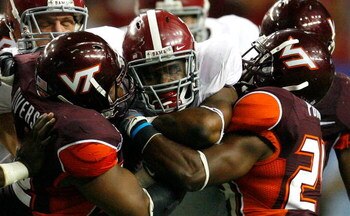 ATLANTA - SEPTEMBER 05:  Running back Mark Ingram #22 of the Alabama Crimson Tide rushes against Barquell Rivers #52 and Dorian Porch #24 of the Virginia Tech Hokies during the Chick-fil-A Kickoff Game at Georgia Dome on September 5, 2009 in Atlanta, Geor