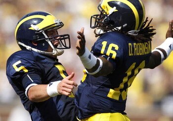 ANN ARBOR, MI - SEPTEMBER 05:  Tate Forcier #5 of the Michigan Wolverines celebrates with Denard Robinson #16 after Robinson ran for a long first quarter touchdown against the Western Michigan Broncos on September 5, 2009 at Michigan Stadium in Ann Arbor,