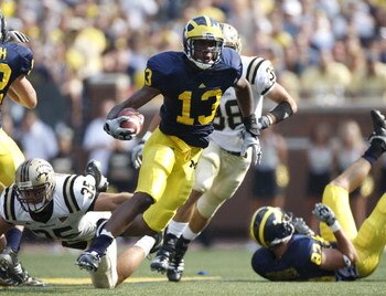 ANN ARBOR, MI - SEPTEMBER 05:  Greg Mathews #13 of the Michigan Wolverines gets past Austin Pritchard #35 of the Western Michigan Broncos during a punt return on September 5, 2009 at Michigan Stadium in Ann Arbor, Michigan.  (Photo by Gregory Shamus/Getty
