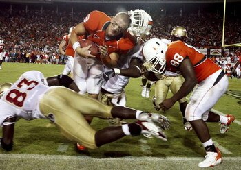MIAMI - SEPTEMBER 4:  Quarterback Kyle Wright #3 of the University of Miami Hurricanes has his helmet knocked off after being hit by linebacker Lawrence Timmons #83 of the Florida State Seminoles at the Orange Bowl Stadium on September 4, 2006 in Miami, F