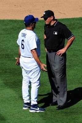 LOS ANGELES, CA - AUGUST 23: Manager Joe Torre #6 of the Los Angeles Dodgers argues with umpire after a controversial play against the Chicago Cubs on August 23, 2009 at Dodger Stadium in Los Angeles, California. The Cubs defeated the Dodgers 3-1.  (Photo