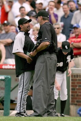 CHICAGO - JUNE 20:  Ozzie Guillen #13 of the Chicago White Sox argues the call with home plate umpire Tim McClelland during the game against the Chicago Cubs on June 20, 2008 at Wrigley Field in Chicago, Illinois. The Cubs defeated the White Sox 4-3. (Pho