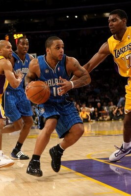 LOS ANGELES, CA - JANUARY 16: Jameer Nelson #14 of the Orlando Magic drives against Andrew Bynum #17 of the Los Angeles Lakers on January 16, 2009 at Staples Center in Los Angeles, California. The Magic won 109-103. NOTE TO USER: User expressly acknowledg