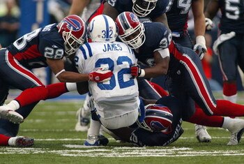 ORCHARD PARK, NY - NOVEMBER 23:  Kevin Thomas #28 and Lawyer Milloy #36 of the Buffalo Bills gang tackle Edgerring James #32 of the Indianapolis Colts on November 23, 2003 at Ralph Wilson Stadium in Orchard Park, New York. The Colts defeated the Bills 17-