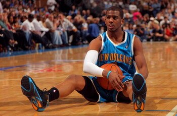 DENVER - APRIL 22:  Chris Paul #3 of the New Orleans Hornets sits on the court after being fouled by Nene #31 of the Denver Nuggets in Game Two of the Western Conference Quarterfinals during the 2009 NBA Playoffs at Pepsi Center on April 22, 2009 in Denve