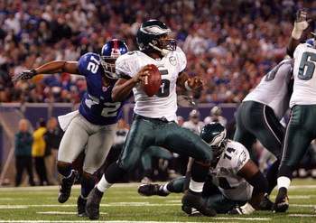 EAST RUTHERFORD, NJ - SEPTEMBER 30: Donovan McNabb #5 of the Philadelphia Eagles gets sacked by Osi Umenyiora #72 of the New York Giants at Giants Stadium on September 30, 2007 in East Rutherford, New Jersey. (Photo by Nick Laham/Getty Images)