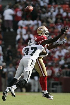 SAN FRANCISCO - AUGUST 22:  San Francisco 49ers wide receiver Josh Morgan #84 goes up for the ball as Oakland Raiders cornerback Chris Johnson #37 defends during the 1st quarter as the San Francisco 49ers host the Oakland Raiders at Candlestick Park Augus