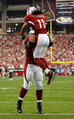 GLENDALE, AZ - JANUARY 18:  Wide receiver Larry Fitzgerald #11 of the Arizona Cardinals celebrates with guard Reggie Wells #74, after a touchdown in the second quarter against the Philadelphia Eagles during the NFC championship game on January 18, 2009 at