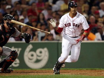 BOSTON - SEPTEMBER 08:  Victor Martinez #41 of the Boston Red Sox drives in a run as Matt Wieters #15 of the Baltimore Orioles defends on September 8, 2009 at Fenway Park in Boston, Massachusetts.  (Photo by Elsa/Getty Images)
