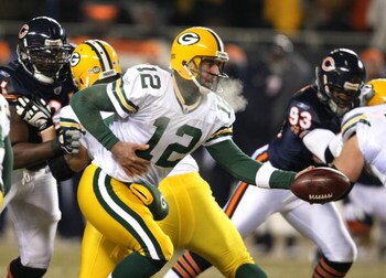 CHICAGO - DECEMBER 22: Aaron Rodgers #12 of the Green Bay Packers turns to hand off against the Chicago Bears on December 22, 2008 at Soldier Field in Chicago, Illinois. The Bears defeated the Packers 20-17 in overtime. (Photo by Jonathan Daniel/Getty Ima