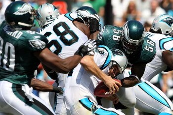 CHARLOTTE, NC - SEPTEMBER 13:  Quarterback Jake Delhomme #17 of the Carolina Panthers is sacked by Linebacker Jordan Akeem #56, of the Philadelphia Eagles in the first half of the NFL season opener at Bank of America Stadium on September 13, 2009 in Charl