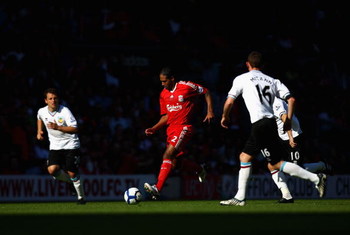LIVERPOOL, ENGLAND - SEPTEMBER 12: Glen Johnson of Liverpool takes on the Burnley defenders during the Barclays Premier League match between Liverpool and Burnley at Anfield on September 12, 2009 in Liverpool, England. (Photo by Ryan Pierse/Getty Image