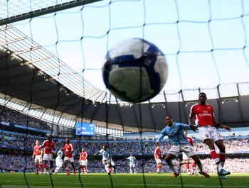 MANCHESTER, ENGLAND - SEPTEMBER 12:  Joleon Lescott (2nd R) of Manchester City watches team-mate Micah Richards' header hit the back of the net during the Barclays Premier League match between Manchester City and Arsenal at the City of Manchester Stadium 