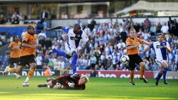 BLACKBURN, ENGLAND - SEPTEMBER 12: Jason Roberts of Blackburn Rovers sets up the third goal for team mate David Dunn (R) to poach on the line during the Barclays Premier League match between Blackburn Rovers and Wolverhampton Wanderers at Ewood Park on Se