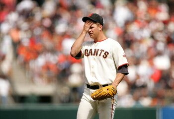 SAN FRANCISCO - AUGUST 30:  Matt Cain #18 of the San Francisco Giants reacts after giving up a triple to Ian Stewart #9 of the Colorado Rockies in the fifth inning of their game at AT&T Park on August 30, 2009 in San Francisco, California.  (Photo by Ezra