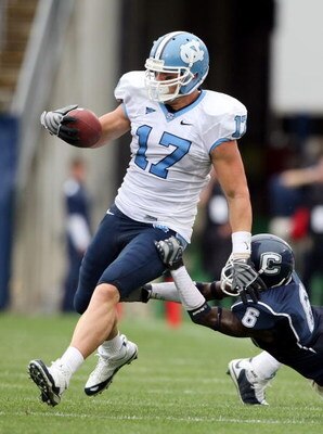EAST HARTFORD, CT - SEPTEMBER 12:  Zack Pianalto #17 of the North Carolinia Tar Heels carries the ball as Jasper Howard #6 of the Connecticut Huskies makes the tackle on September 12, 2009 at Rentschler Field in East Hartford, Connecticut. The Tar Heels d