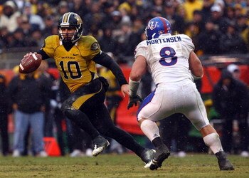 KANSAS CITY, MO - NOVEMBER 29:  Quarterback Chase Daniel #10 of the Missouri Tigers scrambles while trying to evade Joe Mortensen #8 of the Kansas Jayhawks during the game on November 29, 2008 at Arrowhead Stadium in Kansas City, Missouri.  (Photo by Jami