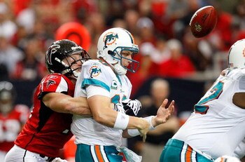 ATLANTA - SEPTEMBER 13:  Kroy Biermann #71 of the Atlanta Falcons forces a fumble by quarterback Chad Pennington #10 of the Miami Dolphins at Georgia Dome on September 13, 2009 in Atlanta, Georgia.  (Photo by Kevin C. Cox/Getty Images)