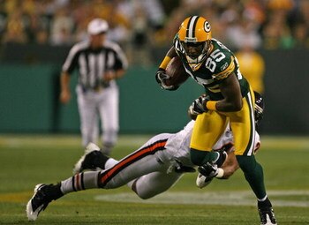 GREEN BAY, WI - SEPTEMBER 13: Greg Jennings #85 of the Green Bay Packers breaks away from Al Afalava #24 of the Chicago Bears on September 13, 2009 at Lambeau Field in Green Bay, Wisconsin. (Photo by Jonathan Daniel/Getty Images)