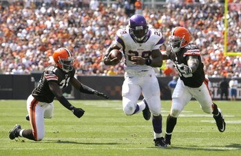 CLEVELAND - SEPTEMBER 13:  Adrian Peterson #28 of the Minnesota Vikings runs by Brodney Pool #21 and Corey Willams #99 of the Cleveland Brwons at Cleveland Browns Stadium on September 13, 2009 in Cleveland, Ohio.  (Photo by Matt Sullivan/Getty Images)
