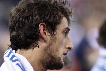 MADRID, SPAIN - SEPTEMBER 12:  Marco Belinelli of Italy reacts as he is being treated for a foot injury during the FIBA Eurobasket 2007 qualifying round group F match between Germany and Italy at the Telefonica Arena on September 12, 2007 in Madrid, Spain