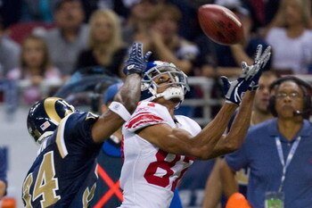 ST. LOUIS, MO - SEPTEMBER 14: Domenik Hixon #87 of the New York Giants catches a pass against Fakhir Brown #34 of the St. Louis Rams at the Edward Jones Dome on September 14, 2008 in St. Louis, Missouri.  The Giants beat the Rams 41-13.   (Photo by Dilip 