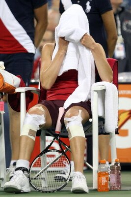 NEW YORK - SEPTEMBER 06:  Vera Zvonareva of Russia sits on her bench with a towel on her head during a break in play against Flavia Pennetta of Italy during day seven of the 2009 U.S. Open at the USTA Billie Jean King National Tennis Center on September 6