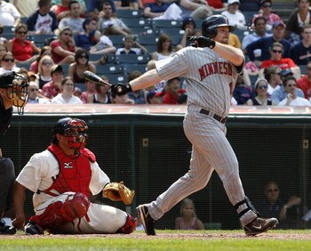 CLEVELAND - JULY 27:  Jason Kubel #16 of the Minnesota Twins hits a single in the ninth inning to score Justin Morneau in front of Sal Fasano #44 of the Cleveland Indians on July 27, 2008 at Progressive Field in Cleveland, Ohio. Minnesota won the game 4-2