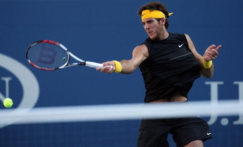 NEW YORK - SEPTEMBER 14: Juan Martin Del Potro of Argentina returns a shot against Roger Federer of Switzerland during the Men's Singles final on day fifteen of the 2009 U.S. Open at the USTA Billie Jean King National Tennis Center on September 14, 2009
